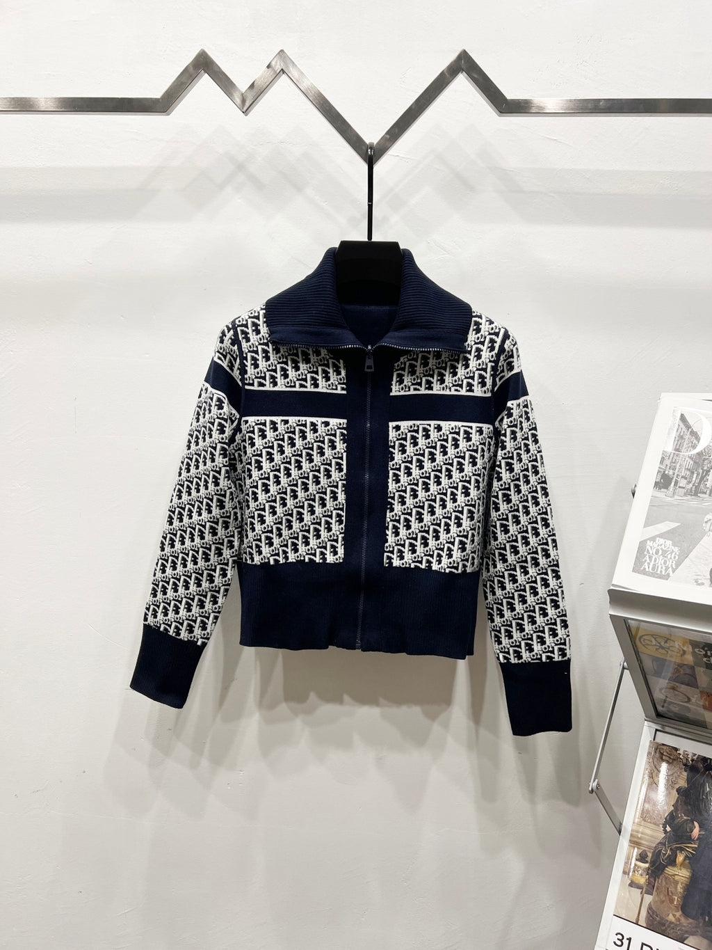 Navy and white long-sleeve zip jacket with stand collar and repeating logo pattern
