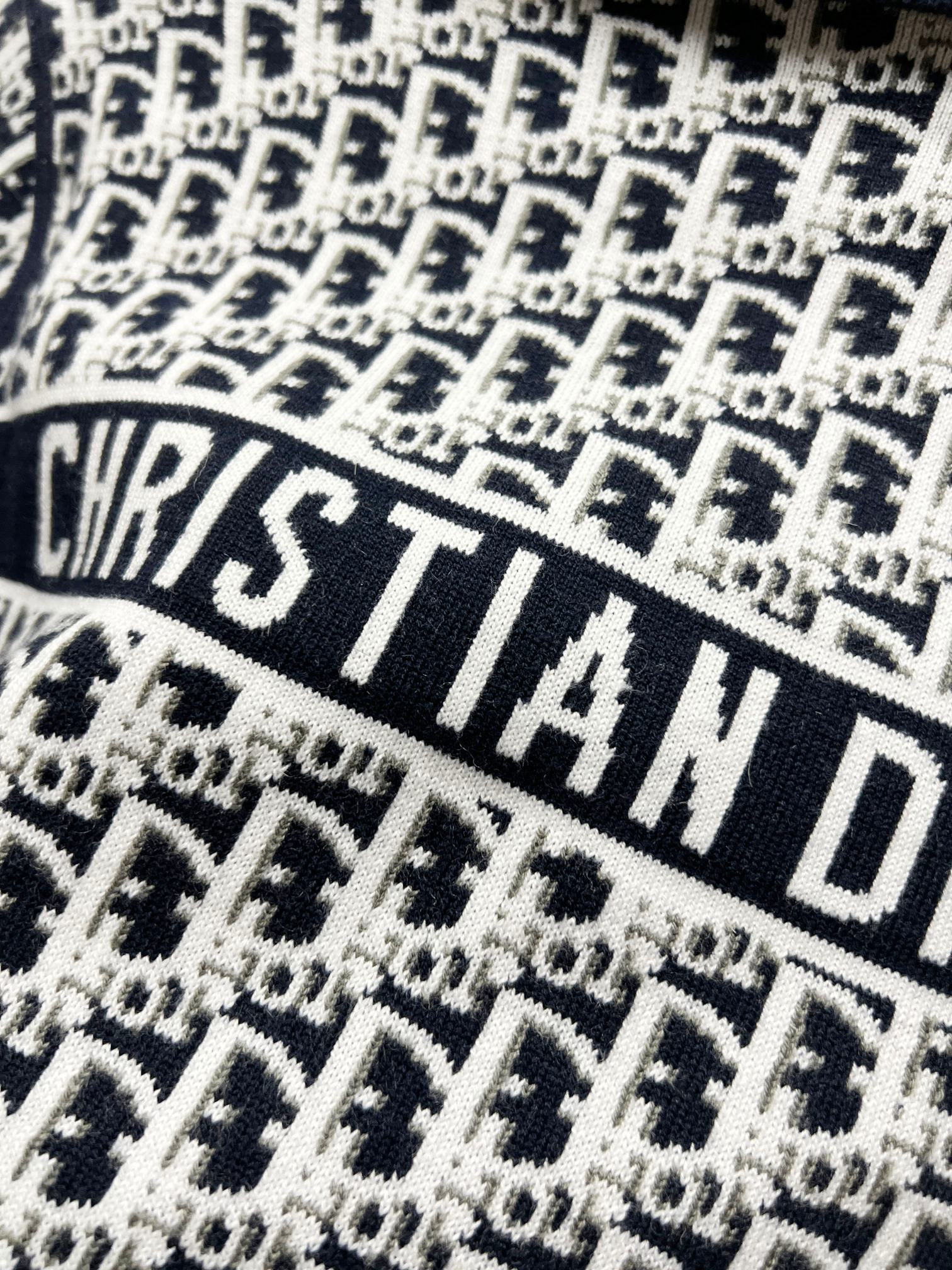 Close-up of navy and white repeating logo knit fabric