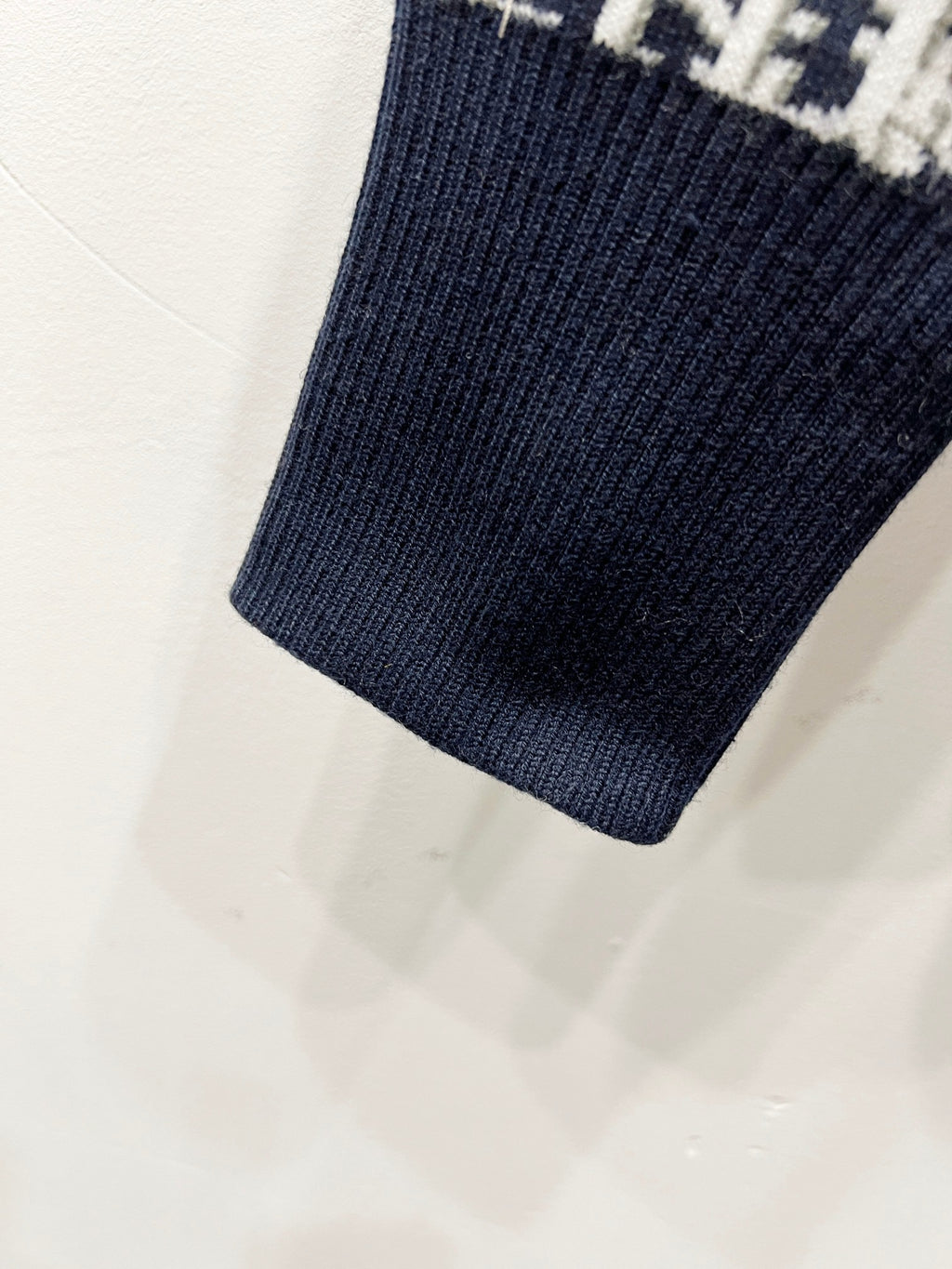 Navy knit sleeve cuff with ribbed hem