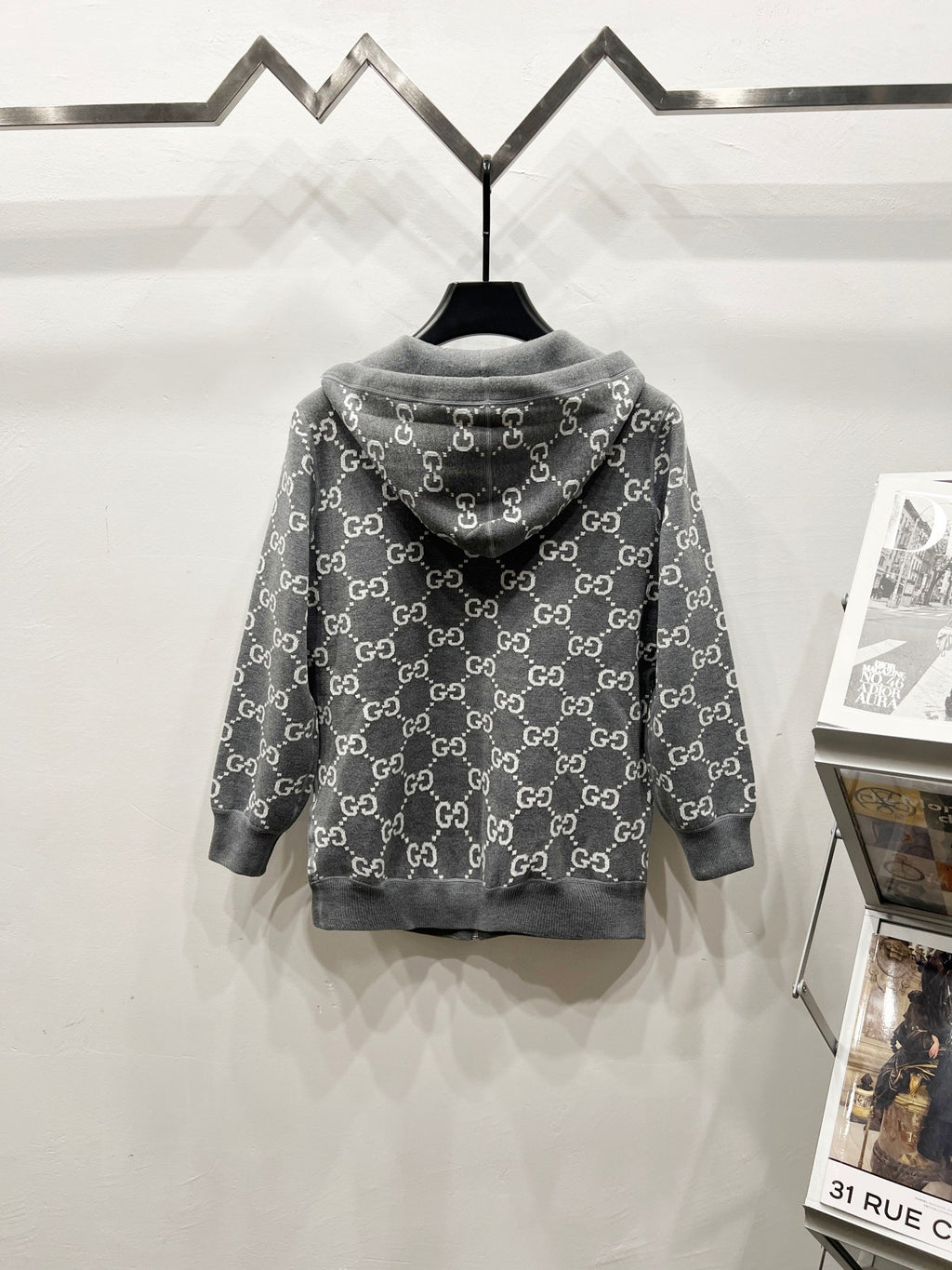 Grey zip-up hoodie with hood, allover monogram pattern, back view