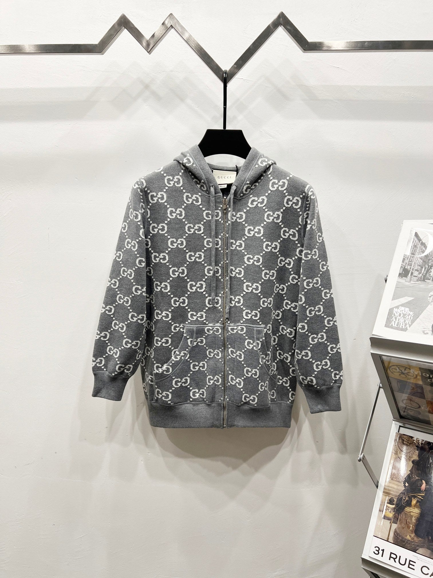 Grey long-sleeve zip-up hoodie with hood and full GG-style monogram pattern
