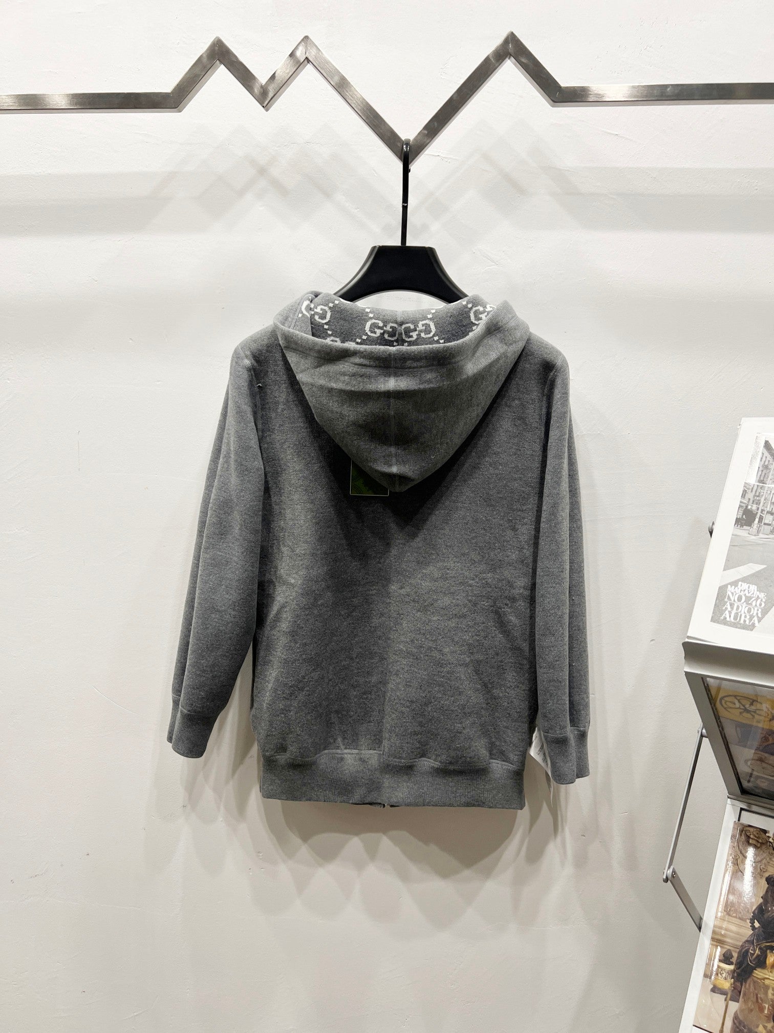 Grey zip-up hoodie with hood, full monogram pattern, back view