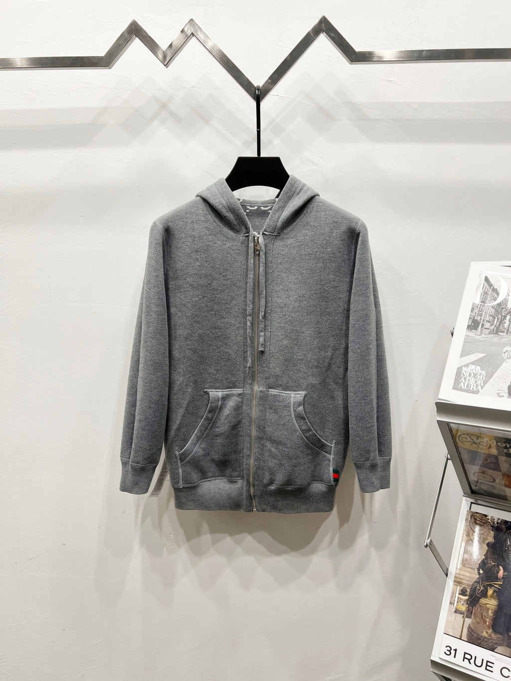 Grey zip-up hoodie with drawstring hood and side pockets, full monogram pattern