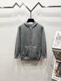 Grey zip-up hoodie with drawstring hood and side pockets, full monogram pattern