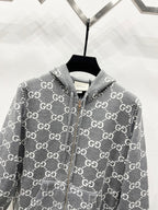 Grey zip-up hoodie with allover monogram pattern and drawstring hood