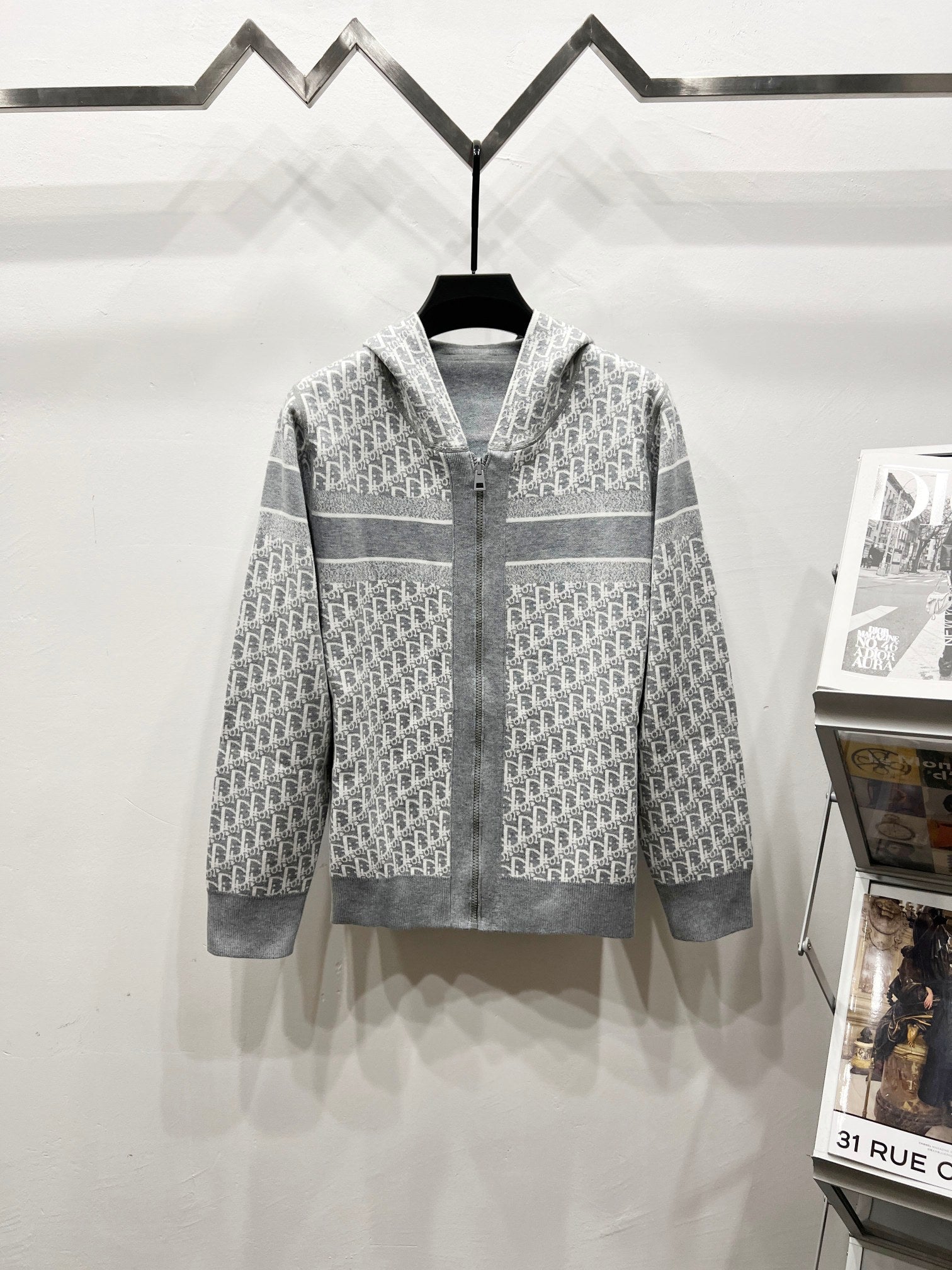 Gray hooded full-zip jacket with Dior-style repeating logo pattern paneling