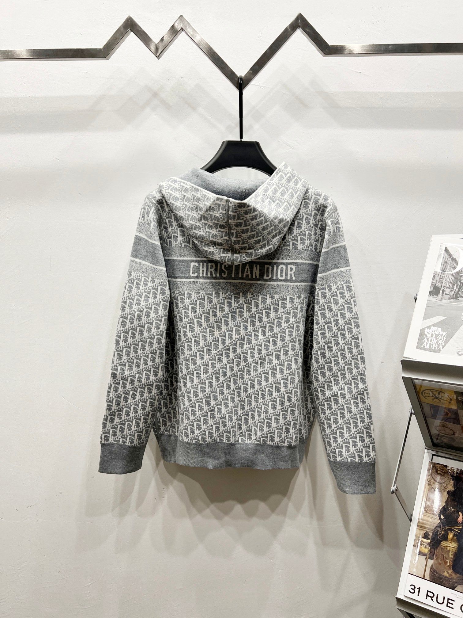 Gray hooded full-zip jacket, back logo text with repeating monogram pattern