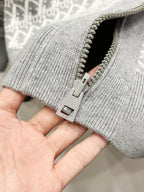 Gray knit hoodie cuff with metal zipper and pull tab