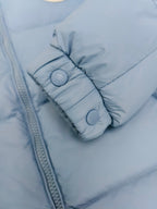 Light blue puffer jacket cuff with snap buttons and quilted padding