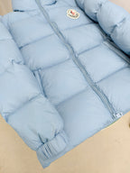Light blue puffer jacket with full-length zipper and quilted padded panels