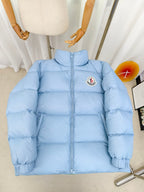Light blue puffer jacket with zip front and Moncler logo patch on chest