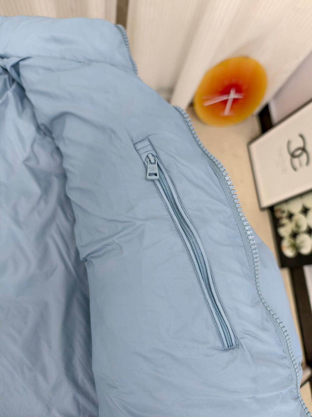 Light blue puffer jacket with center zipper and high stand collar