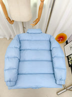 Light blue puffer jacket back view with horizontal quilted stripes and zip
