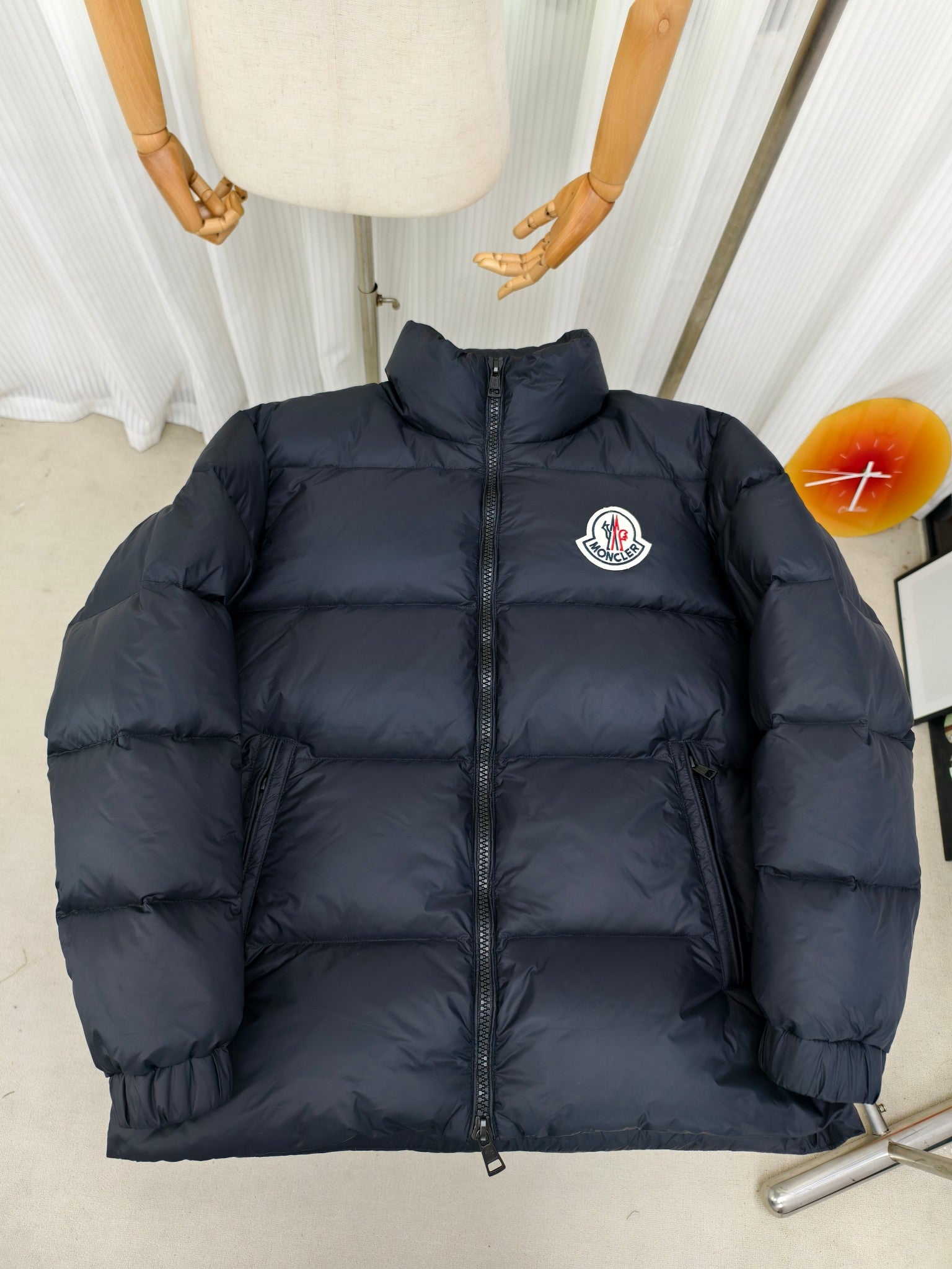 Moncler dark puffer jacket with full front zipper and embroidered logo patch