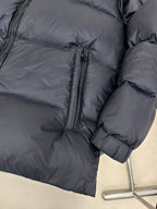 Moncler dark puffer jacket sleeve and side with ribbed cuffs and full-length zipper