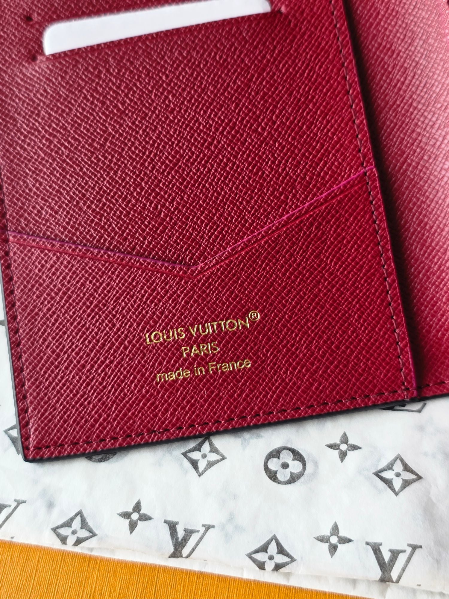Small bag close-up of pink leather with “Louis Vuitton” stamp