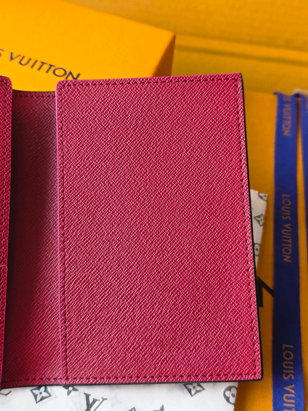 Small bag with pink leather exterior, card-holder style with stitched edges
