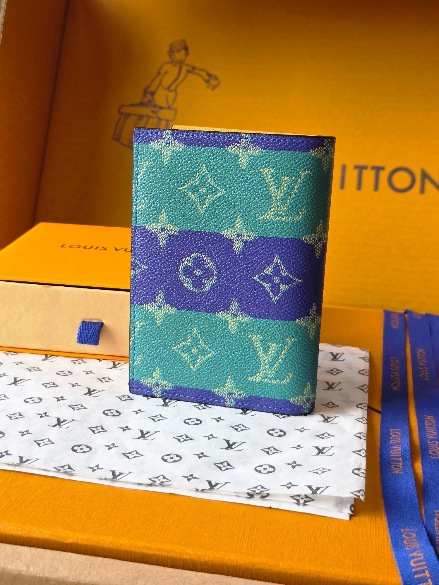 Small bag with turquoise and purple monogram print, front view
