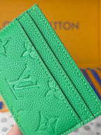 Louis Vuitton green embossed mini bag with lined interior panel and textured grain