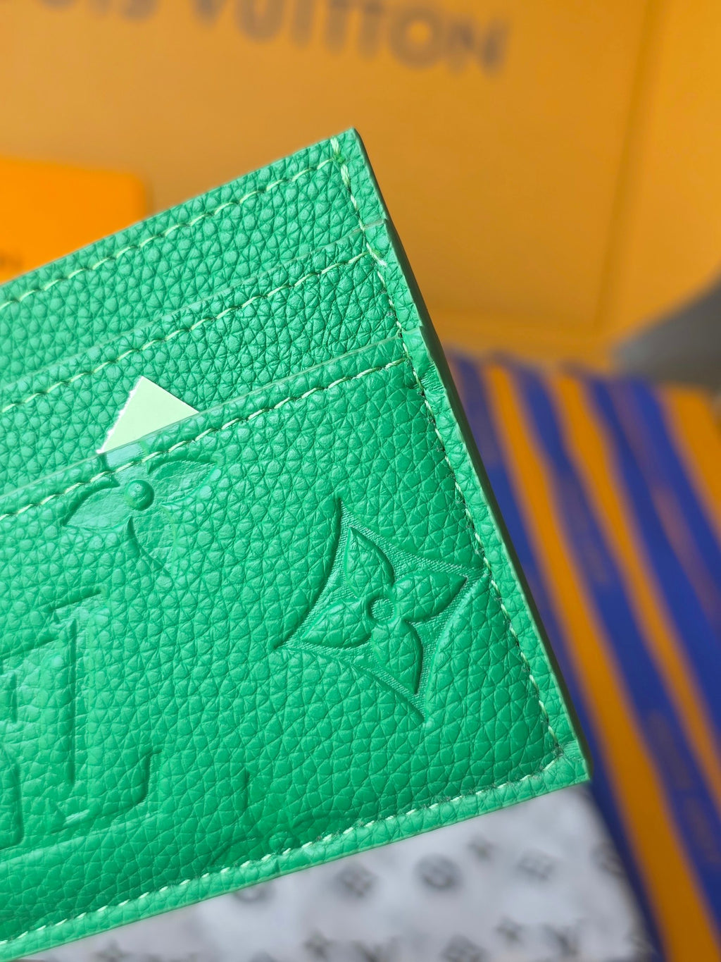 Louis Vuitton green embossed mini bag side with top fold and monogram pattern