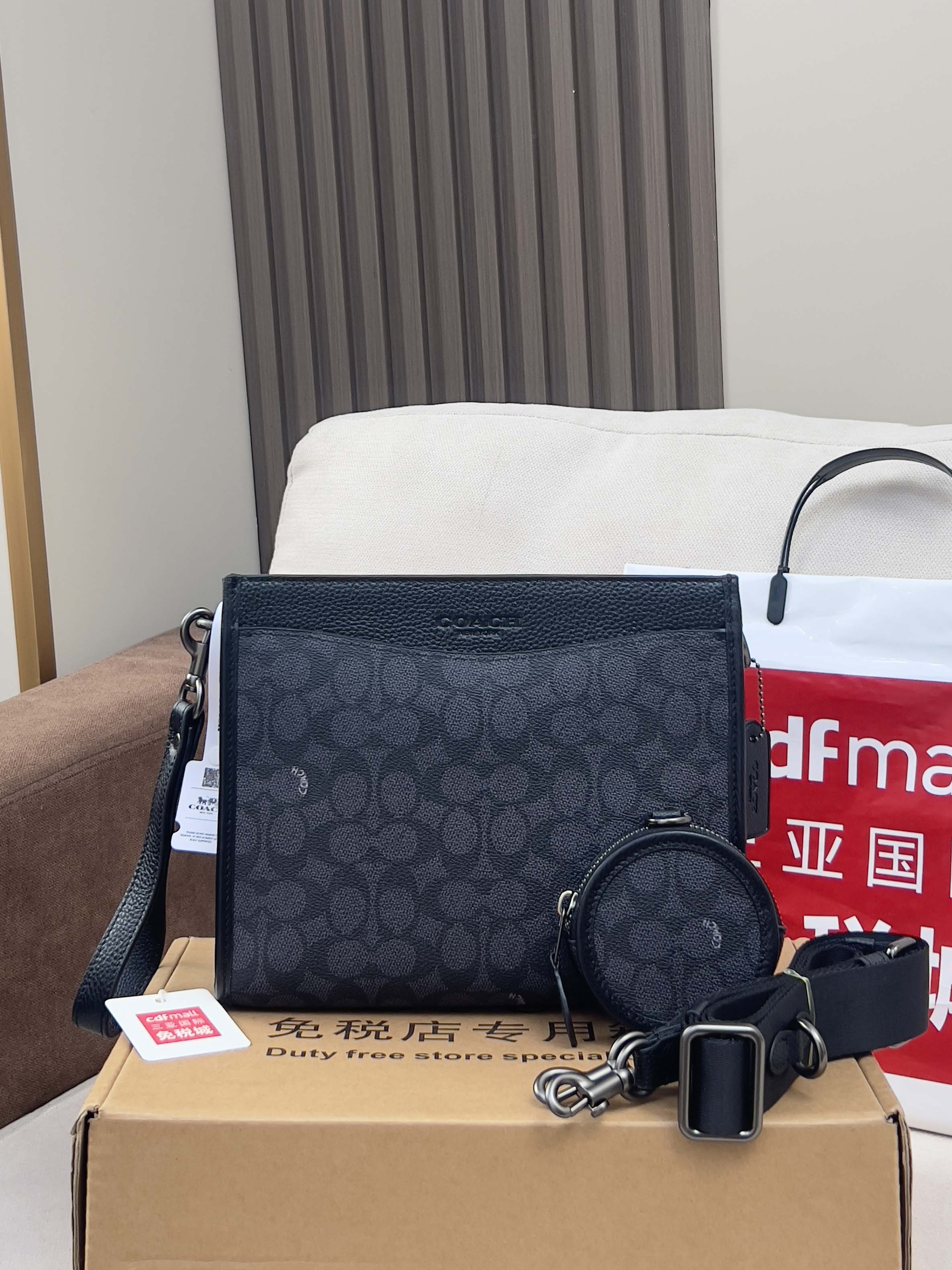 Dark navy patterned handbag with zip top, plus round zip pouch and keychain