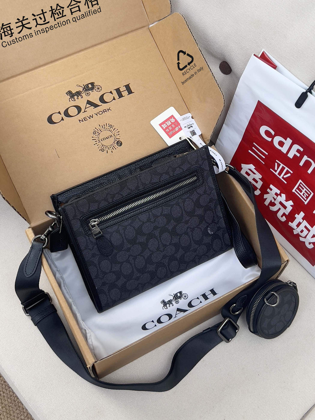 Dark navy patterned crossbody bag with front zip pocket and matching round pouch