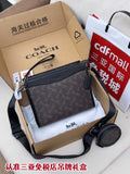 Small dark monogram crossbody bag with zip top and adjustable shoulder strap