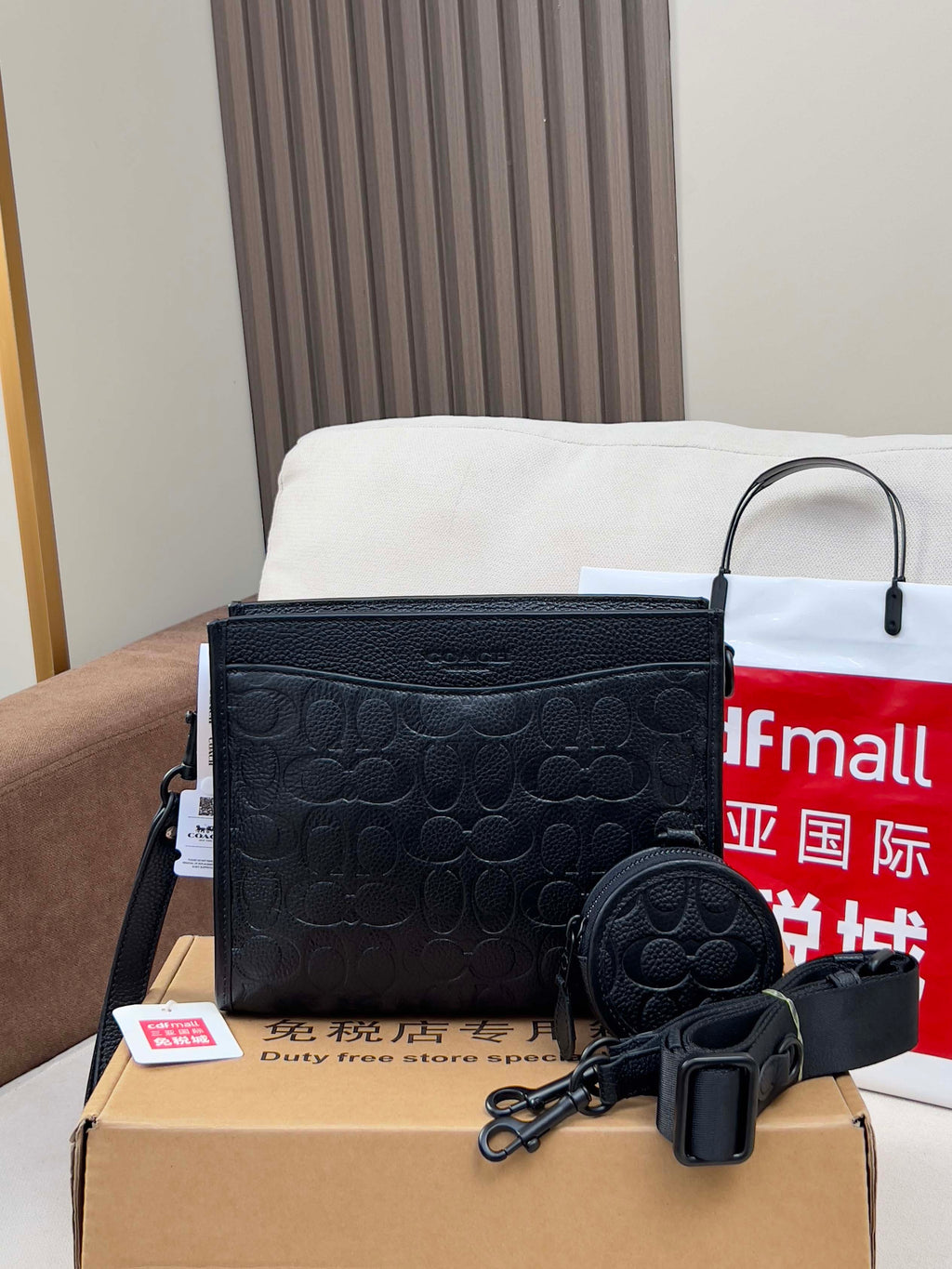 Black COACH crossbody bag with zip top and matching round coin pouch