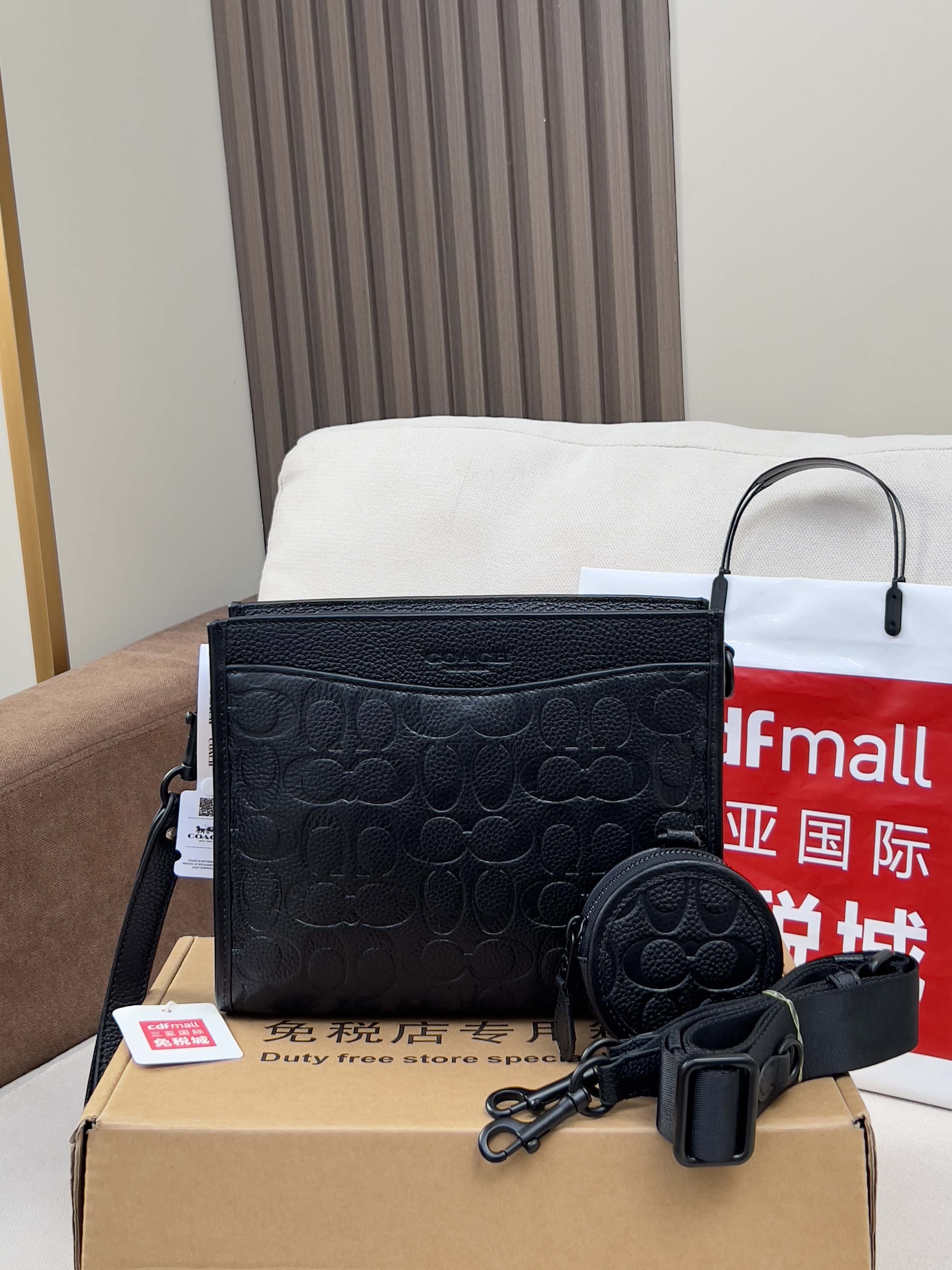 Black COACH crossbody bag with zip top and matching round coin pouch