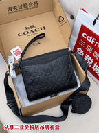 Black COACH logo crossbody bag with zip top and adjustable shoulder strap