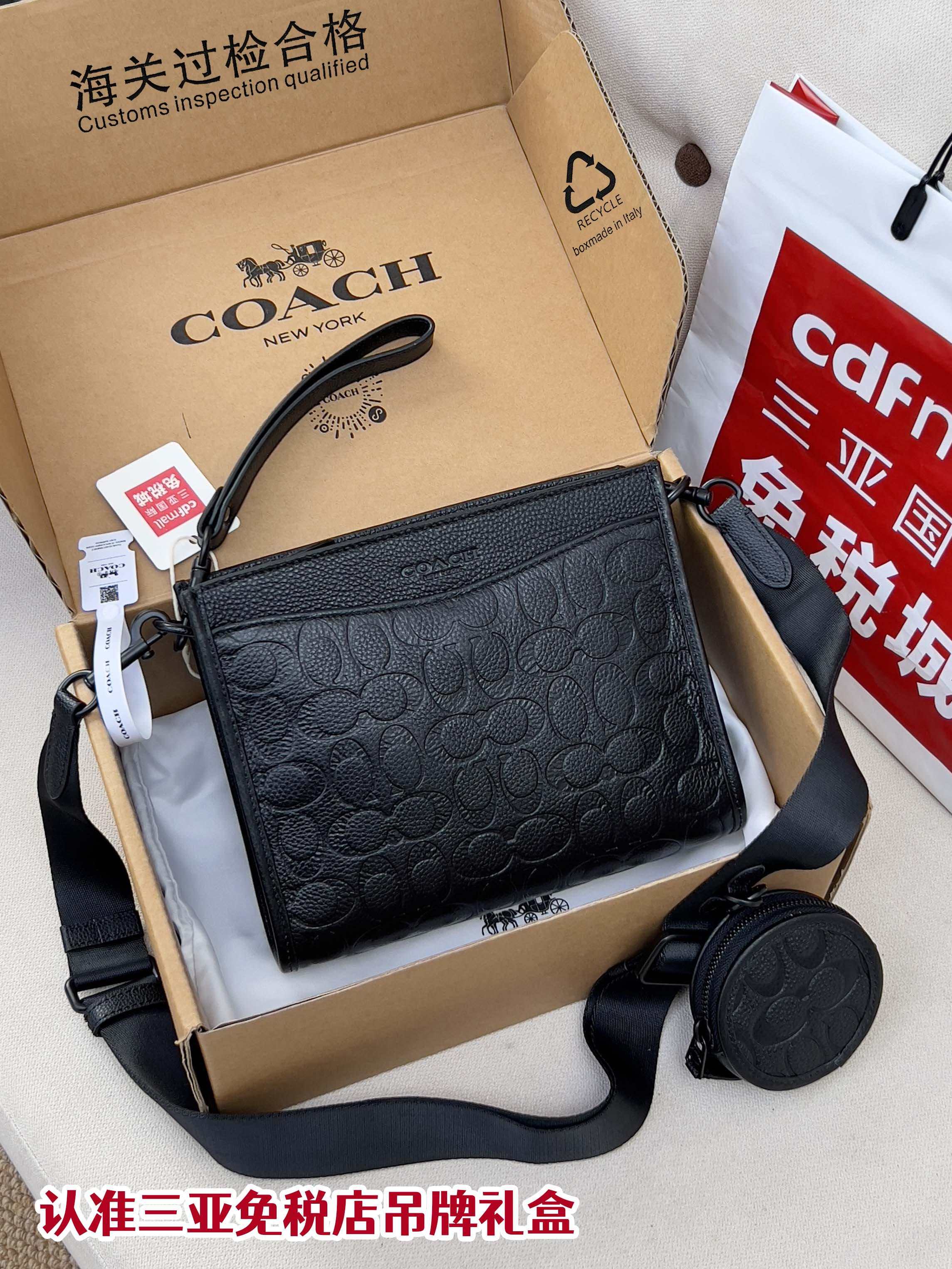 Black COACH logo crossbody bag with zip top and adjustable shoulder strap