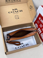 Coah bag with dark monogram canvas, brown leather handle and wrist strap