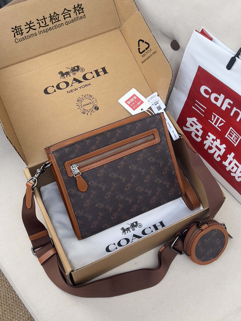 Coah bag with top zip, dark monogram fabric, brown leather trim, crossbody strap