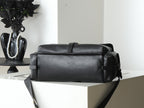 Black leather top handle bag with flap and gold-tone buckles