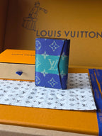 Small card holder front view with blue-and-teal monogram print and compact profile