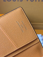 Small card holder corner close-up with embossed Louis Vuitton monogram on tan leather