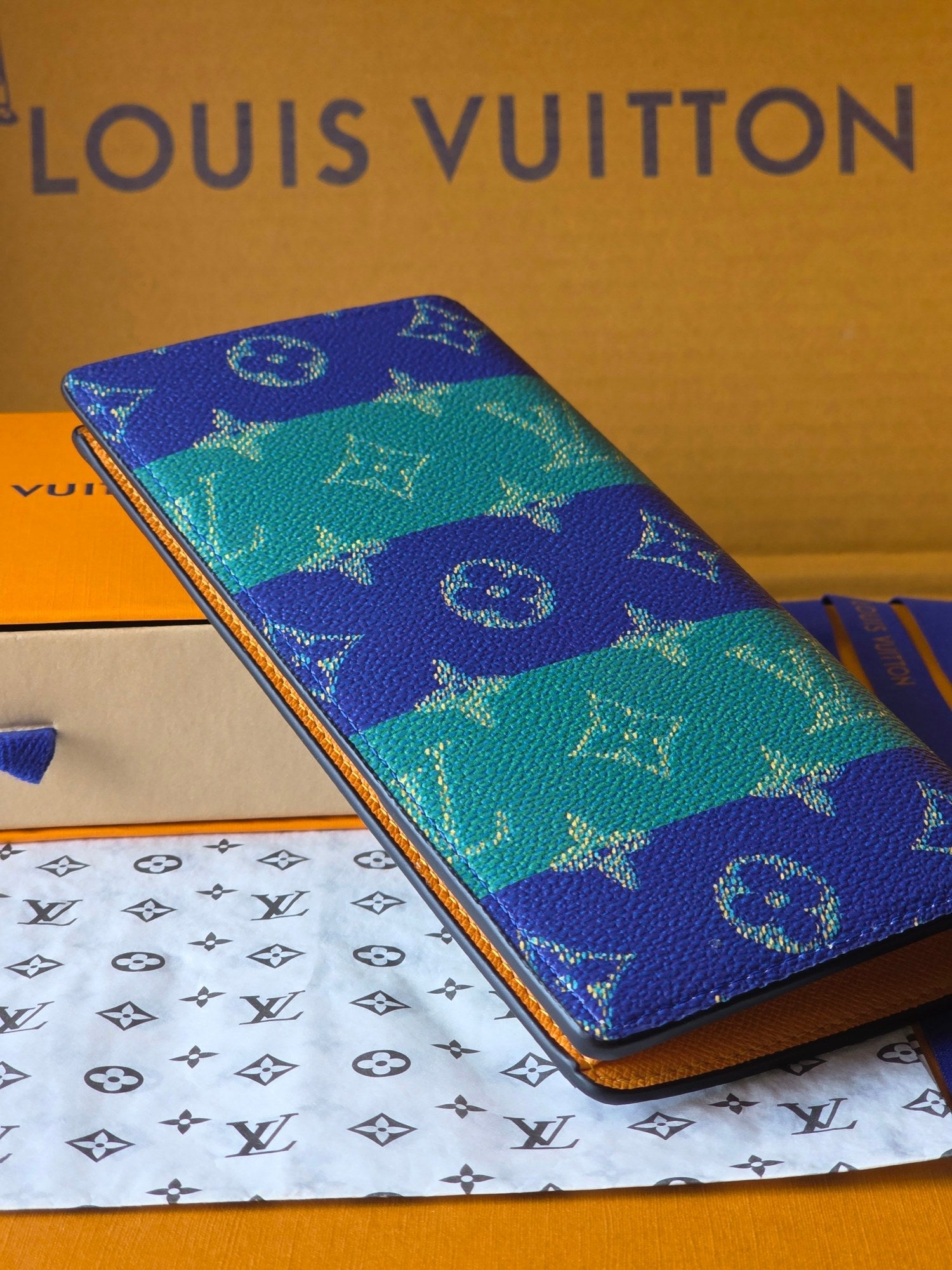 Small card holder side view with blue-and-teal monogram pattern and gold trim
