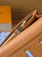 Small card holder interior close-up showing gold zipper and tan lining