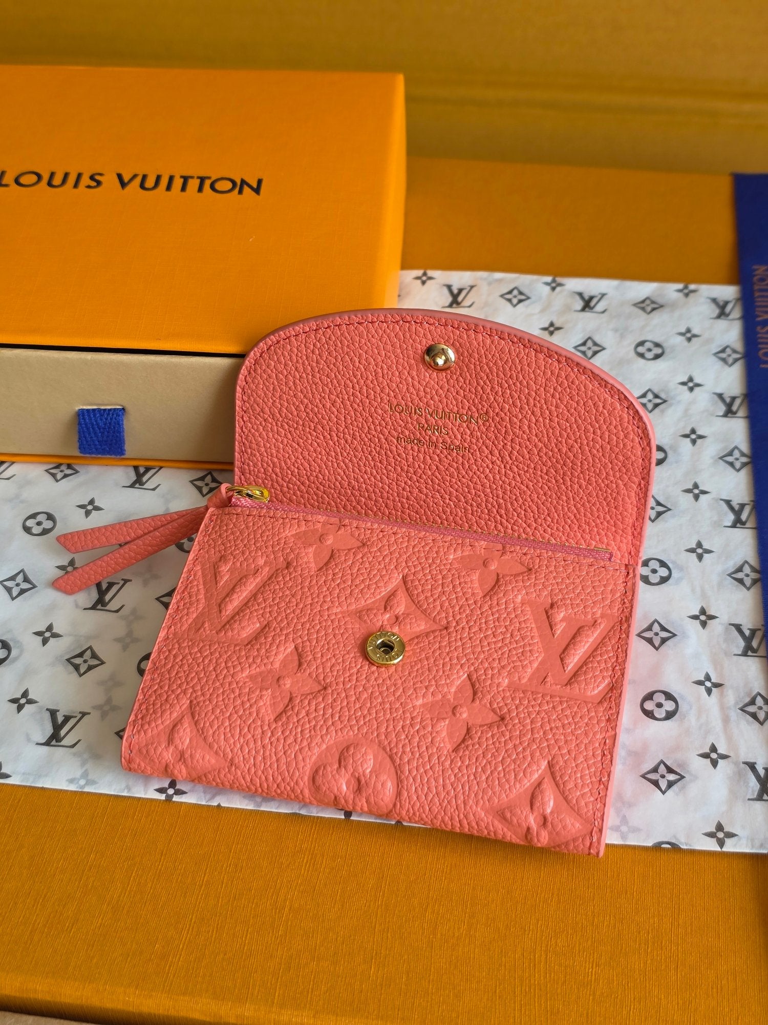 Louis Vuitton pink small bag with curved flap, gold snaps, and embossed monogram