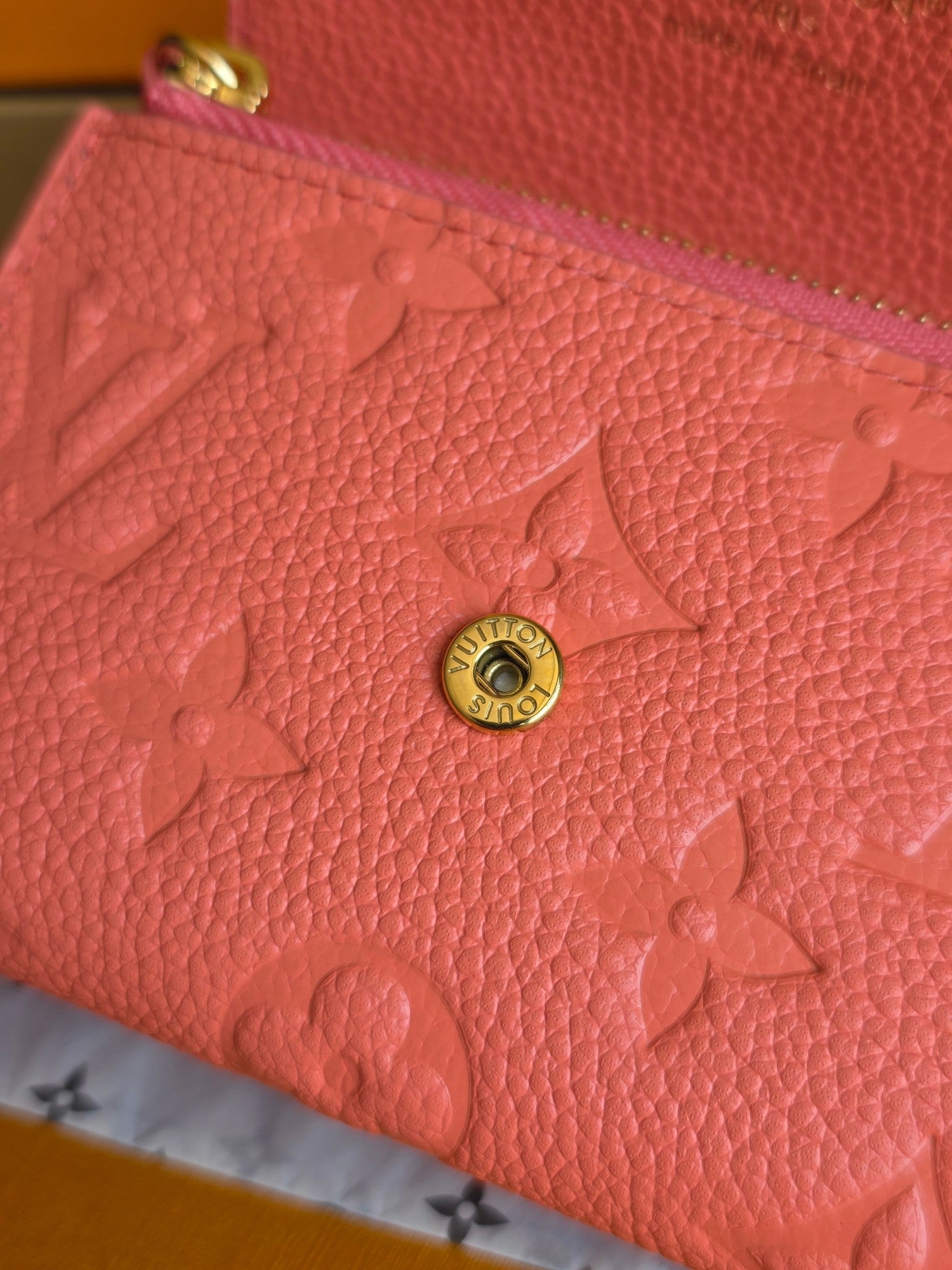 Louis Vuitton pink embossed leather with gold circular snap hardware