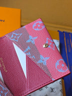 Small Louis Vuitton bag with blue monogram front, side view of button and edge seam