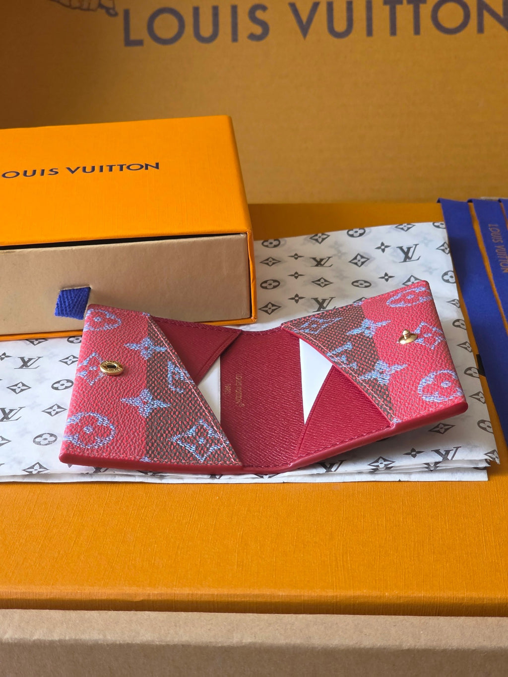 Louis Vuitton monogram wallet with red flap and heart-like pattern
