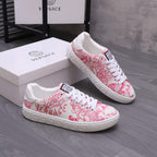 Pink and white patterned lace-up sneakers with white midsole and side logo patch