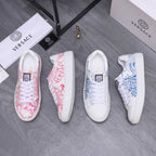 Pink and white patterned low-top sneakers with white rubber sole and lace-up front