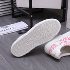 White outsole with textured tread and emblem on low-top sneaker