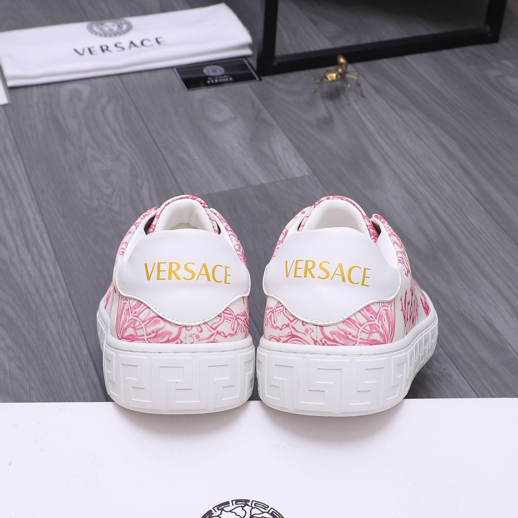 White heel sneakers with pink pattern and yellow logo lettering on back