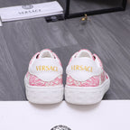 White heel sneakers with pink pattern and yellow logo lettering on back