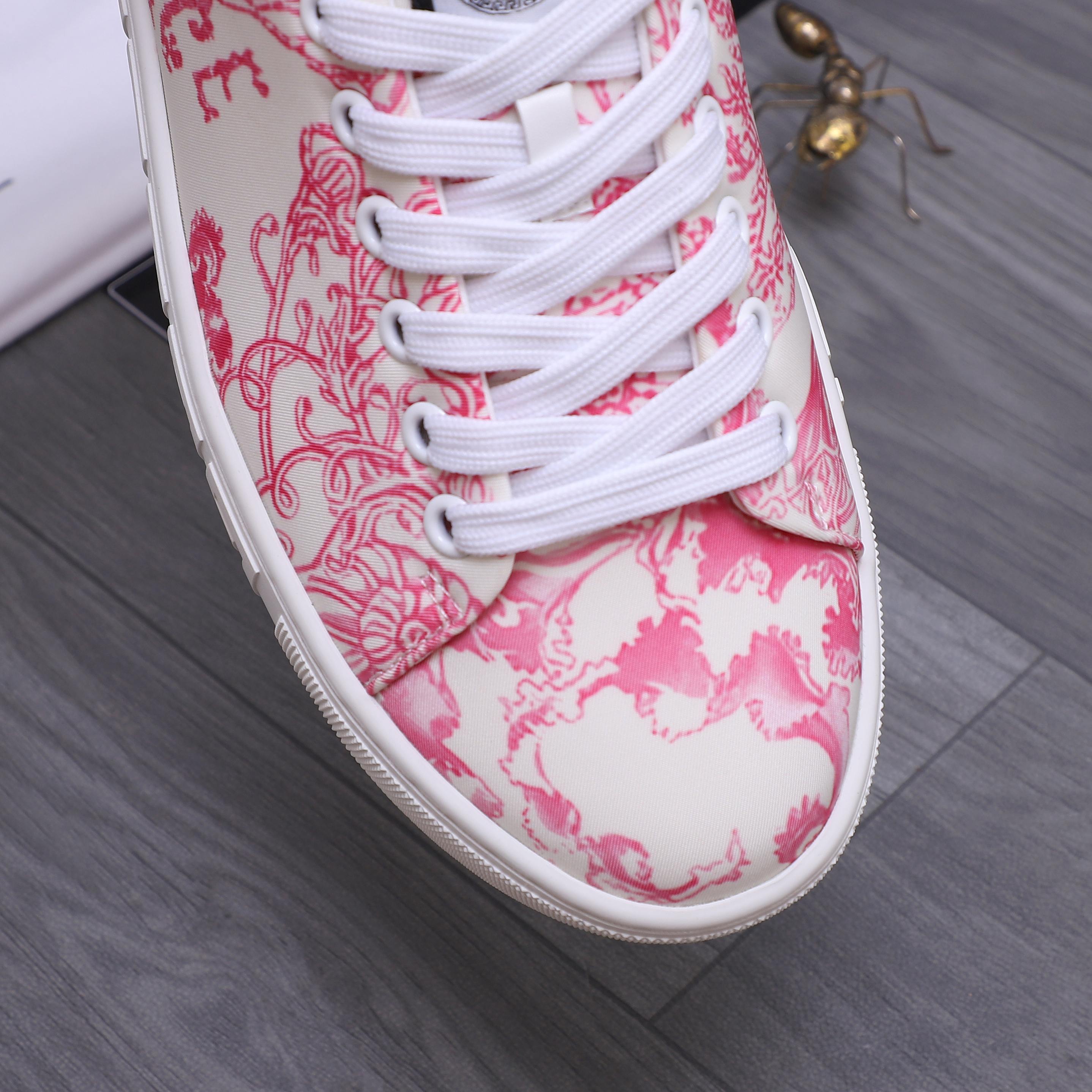 Close-up of pink patterned sneaker toe with white laces and white rubber edge