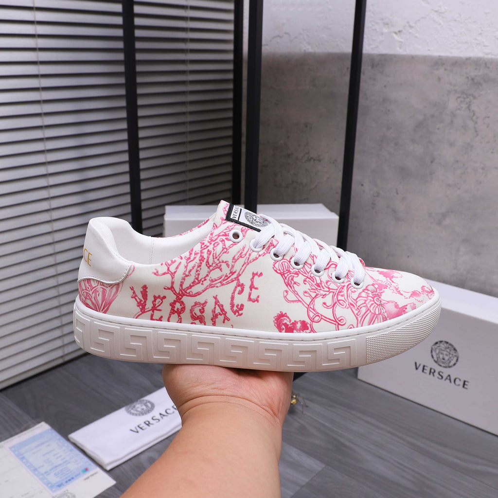 Pink and white patterned lace-up sneakers with white laces and rubber sole