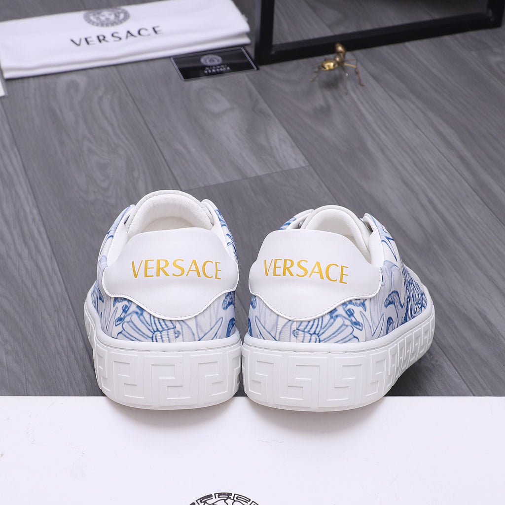 White Versace sneakers with blue pattern at heel, rear view, cushioned collar.